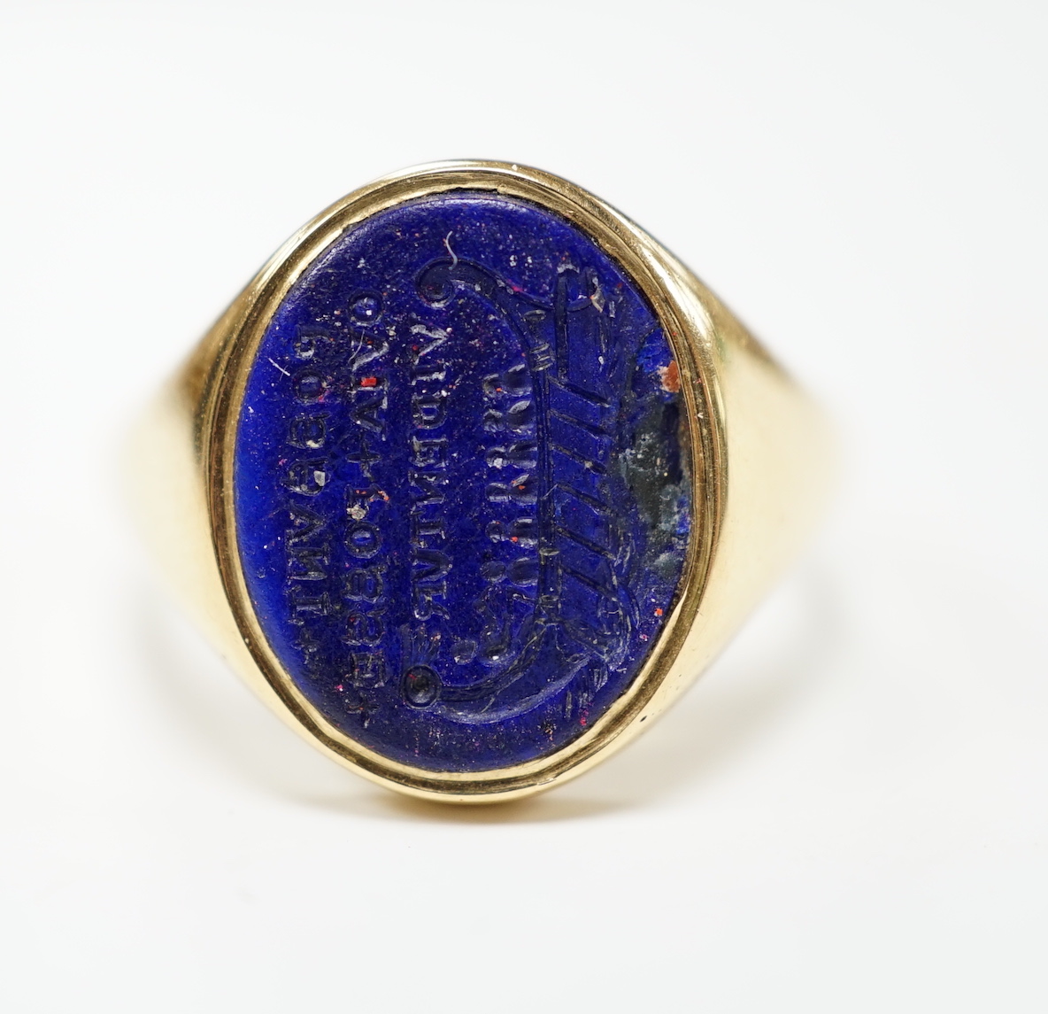 A yellow metal (stamped18) and oval intaglio lapis lazuli seal ring, carved with a longboat and the Latin motto 'Possunt, Quia Posse Videntur' (They Can Because They Think They Can), size Q, gross weight 9.9 grams.